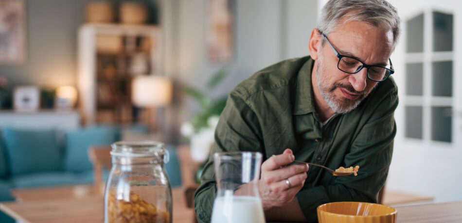 Senior man having breakfast early in the morning.