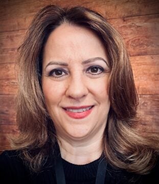 Linda Broderick Headshot in front of brown background