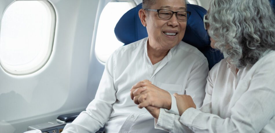 Mature couple sitting a private jet and headed on a trip.