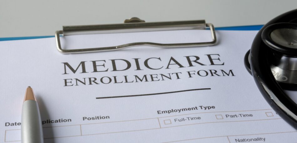 Medicare enrollment form on clipboard.